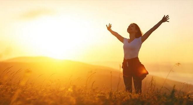 happy-woman-in-nature-at-sunset